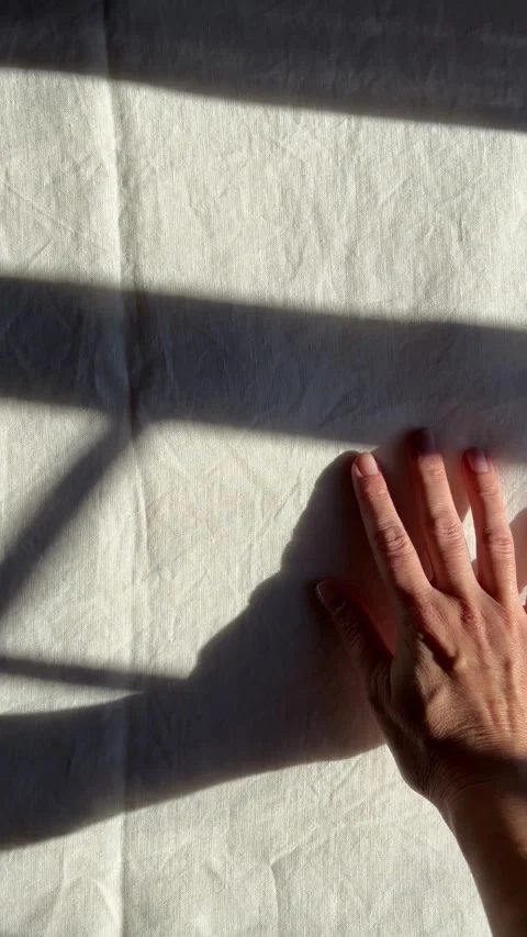 Sunlight and window shadows on white linen bed sheets Stock Footage 330492575
