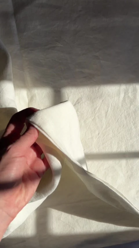 Sunlight and window shadows on white linen bed sheets Video stock 330492584