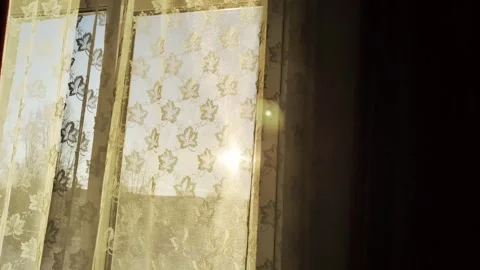 Sunlight in the apartment window through the curtain. Sunset, view from the Stock Footage 303142662