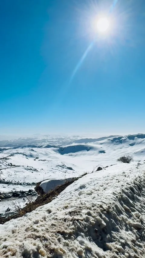 Sunlight beam shining over snowy mountains, vertical view Stock Footage 345154947