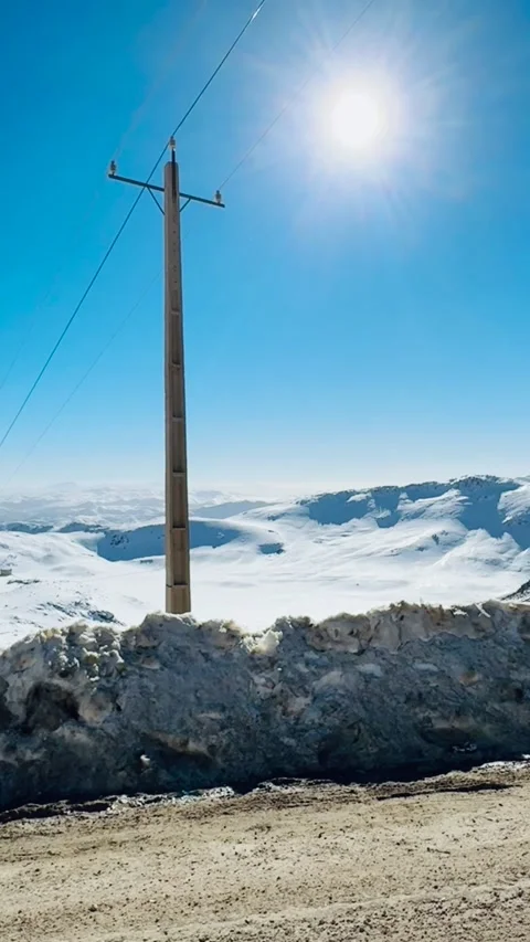 Sunlight beam shining over snowy mountains, vertical view Stock Footage 345155203