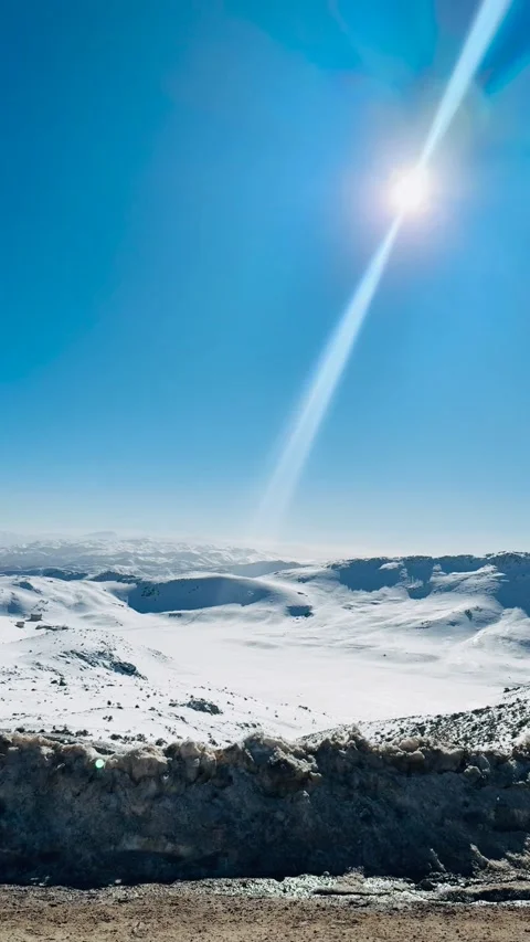 Sunlight beam shining over snowy mountains, vertical view Stock Footage 345155206