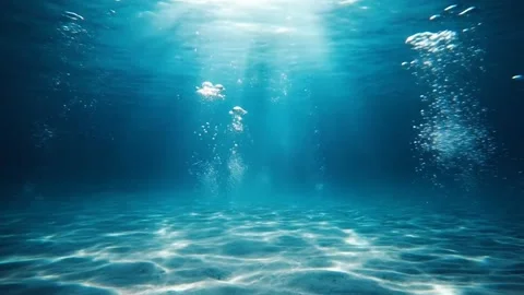 Sunlight beams through clear blue ocean water, creating shimmering patterns Stock Footage 324072265