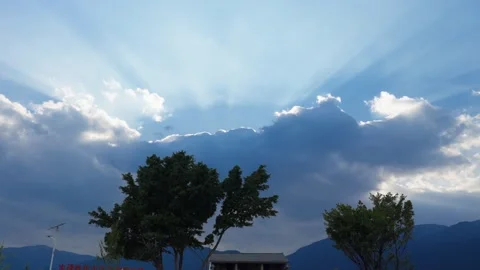 Sunlight Beams Through Clouds – Crepuscular Rays over Yunnan Stock Footage 312449361