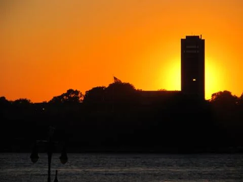 Sunlight behind building shinging through open window Photos