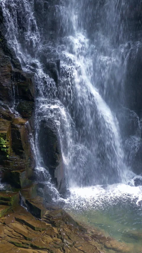 Sunlight Behind Curtain of Waterfall Vertical Video Stock Footage 346195335