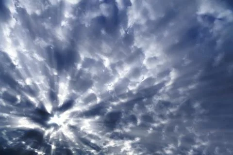Sunlight behind dark clouds Stock Photos