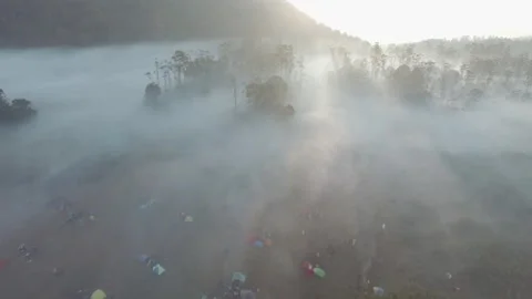 Sunlight behind the mountains with thick fog in the morning Stock Footage 296264742
