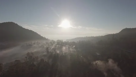 Sunlight behind the mountains with thick fog in the morning Stock Footage 296265075