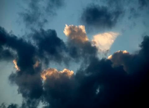 SUNLIGHT BREAKING THROUGH CLOUDS AFTER STORM Stock Photos