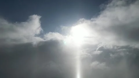 Sunlight breaking through clouds with gradual camera zoom in on scene Stock Footage 319544207