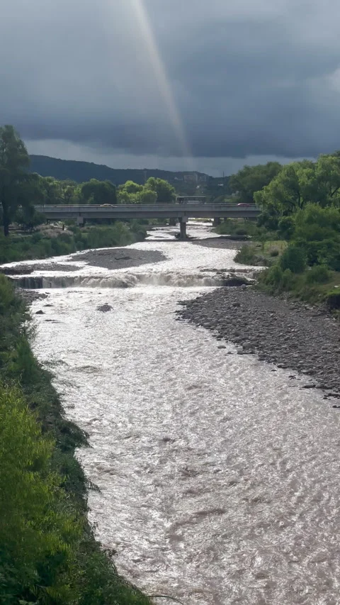 Sunlight Breaking Through Clouds Over River Bridge Stock Footage 331375635