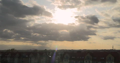 Sunlight breaking through clouds before sunset above the city Stock Footage 252665118