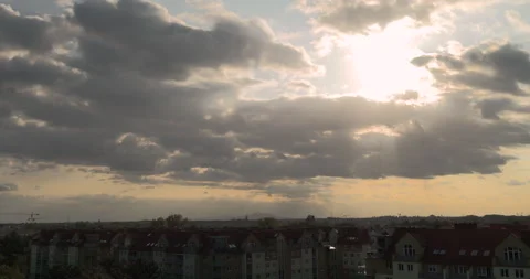 Sunlight breaking through clouds before sunset above the city Stock Footage 252665337