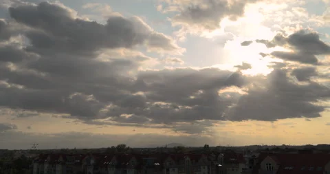 Sunlight breaking through clouds before sunset above the city Stock Footage 252666029