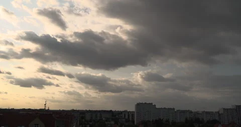 Sunlight breaking through clouds before sunset above the city Stock Footage 252666339