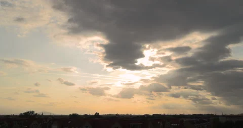 Sunlight breaking through clouds before sunset above the city Stock Footage 252674420