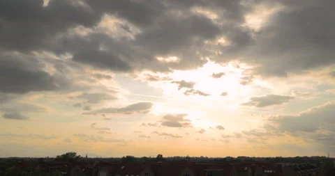 Sunlight breaking through clouds before sunset above the city Stock Footage 252675301