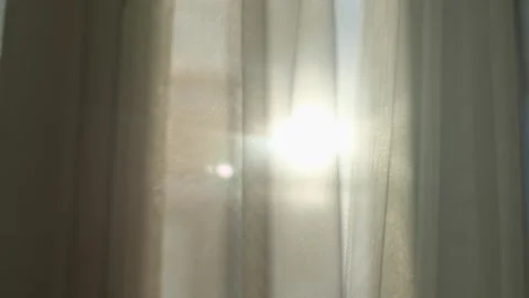 Sunlight breaking through the curtains at dawn, close-up Stock Footage 277661208