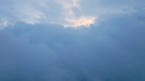Sunlight Breaking Through Dense Blue Gray Clouds in Dramatic Overcast Sky. Stock Footage 338360513