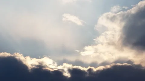 Sunlight Breaking Through Dramatic Clouds in the Sky with Bright Rays and Stock Footage 337788076