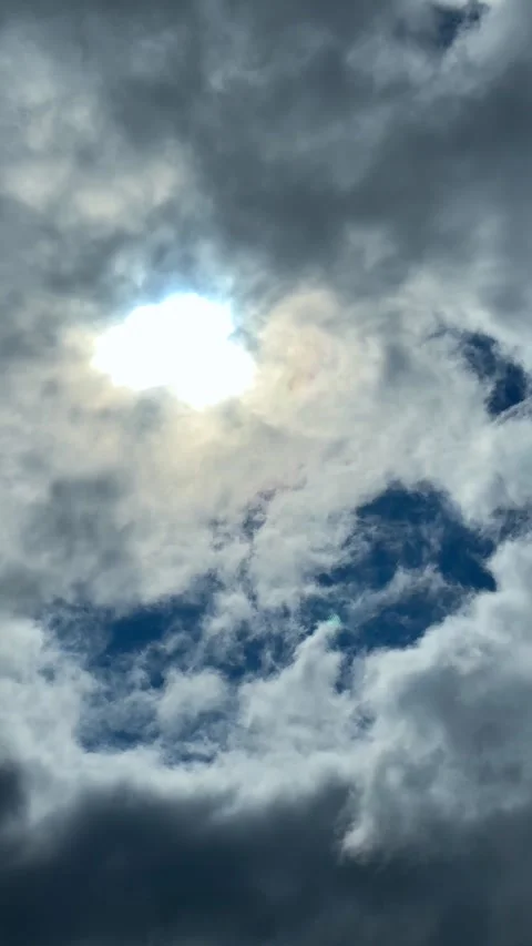 Sunlight breaking through dramatic storm clouds in blue sky Stock Footage 311981931