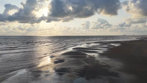 Sunlight breaks through clouds above the ocean Stock-Footage 337990417