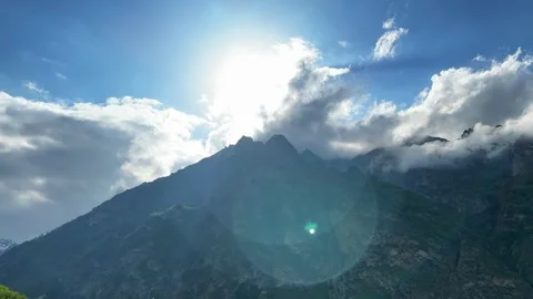 Sunlight breaks through the clouds against the background of the mountains Stock Footage 276541824