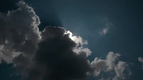 Sunlight breaks through clouds at midday in a serene sky Stock Footage 321458323