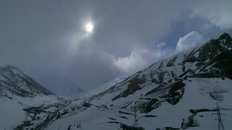 Sunlight breaks through the clouds over the mountains Stock Footage 284125464