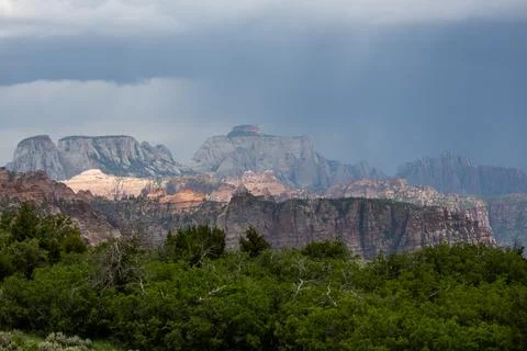 Sunlight Breaks Through Storm Clouds Over Zion Фото