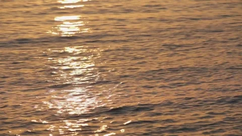 Sunlight on calm flat rippling sea water at sunset Stock Footage 292879297