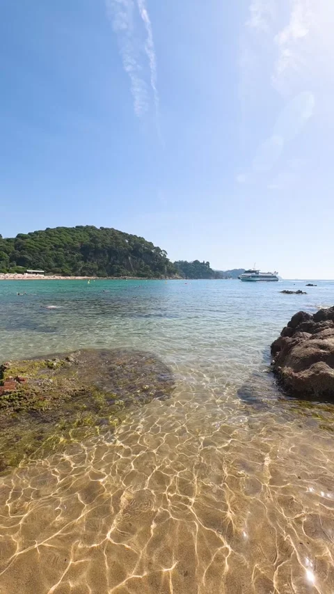 Sunlight casting caustic reflections on the sandy sea bottom as clear turquoise Stock Footage 338405438