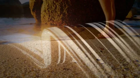 Sunlight casting striped arc across sand, causing barefoot man shifting feet Stock Footage 333901398