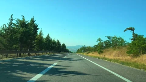 Sunlight casts shadows on a paved road. Macedonia Stock Footage 338347072