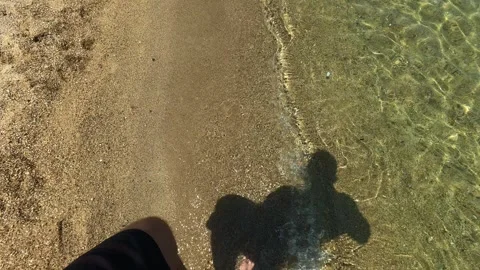 Sunlight casts a strong shadow on wet sand. Trani Ammouda, Greece Stock Footage 338348248