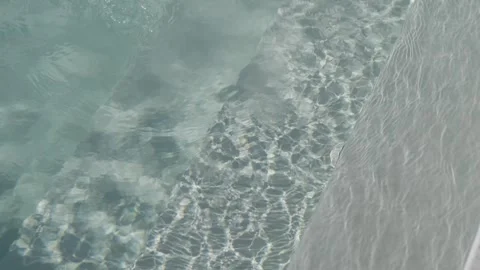 Sunlight Caustics Rippling Over Pebbles In Clear Shallow Water Stock Footage 343705911