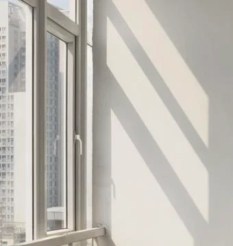 Sunlight comes through the window,shines on the wall Stock Photos