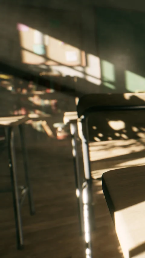 Sunlight creates shadows in a classroom with empty chairs at different angles Stock Footage 338425676