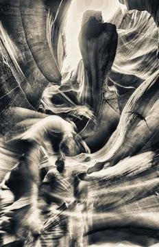 Sunlight creating dramatic patterns on sand and rock formations inside Ante.. Stock Photos