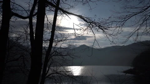 Sunlight Creating Sparkling Reflections on Lake Surface 動画素材 318912642