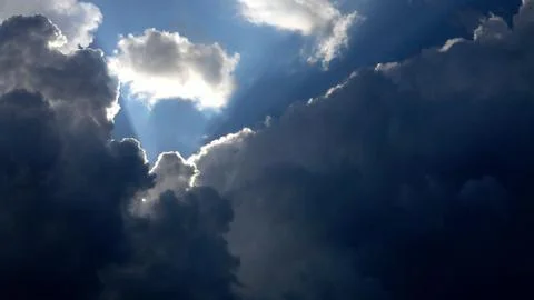 Sunlight cutting through the clouds Stock Photos