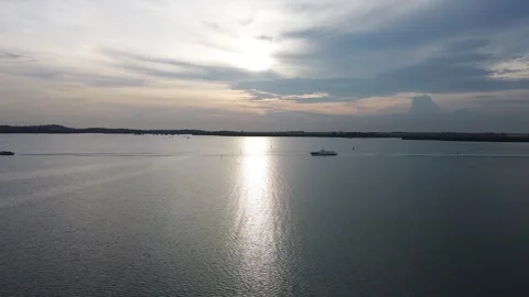 Sunlight danced on the waves as boats sailed along the coast. Stock-Footage 325193631
