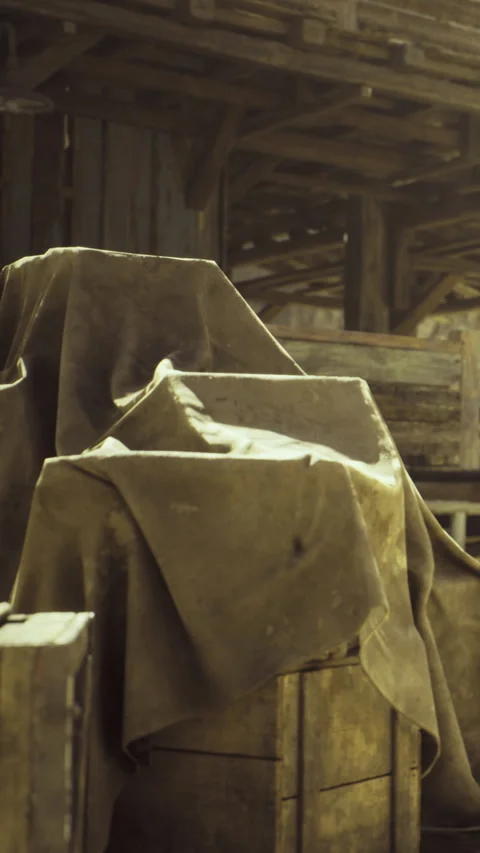 Sunlight dances on draped treasures in an old wooden barn setting Stock Footage 341395514