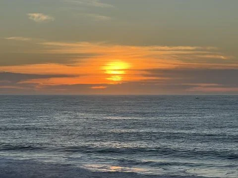 Sunlight Dances on Ocean Waves at Sunset’s Golden Embrace Stock Photos