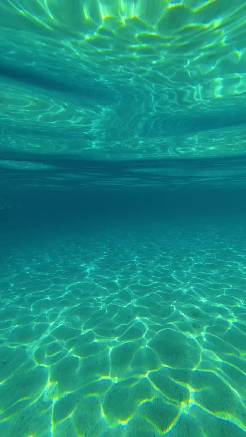 Sunlight dances on the sandy ocean floor. Lagomandra, Greece. Vertical Stock Footage 339627120
