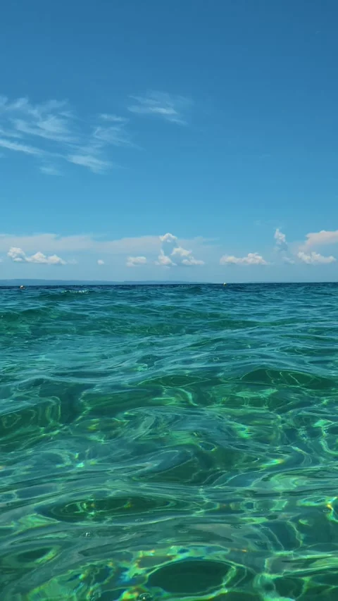 Sunlight dances through turquoise water. Lagomandra, Greece. Vertical Stock Footage 339627330