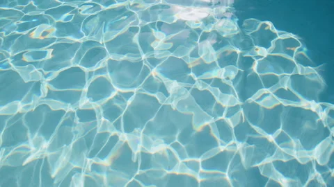 Sunlight dances on the water surface, creating mesmerizing reflections at the Stock Footage 296717008