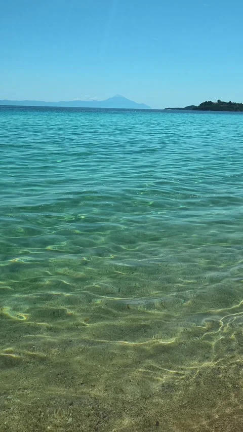 Sunlight dances on water's surface. Trani Ammouda, Greece. Vertical Stock Footage 339629250