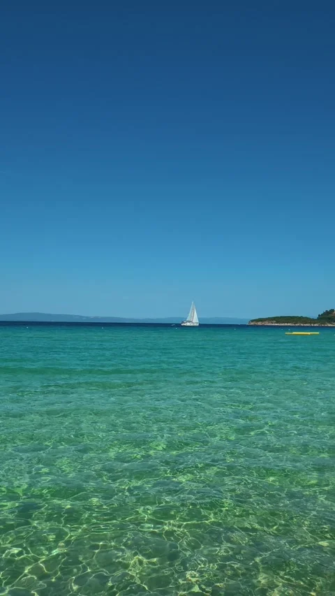Sunlight dances on water's surface. Trani Ammouda, Greece. Vertical Stock Footage 339630306